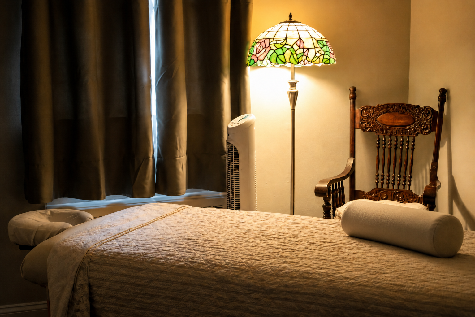 Tranquil massage therapy room with stained glass lamp and antique chair